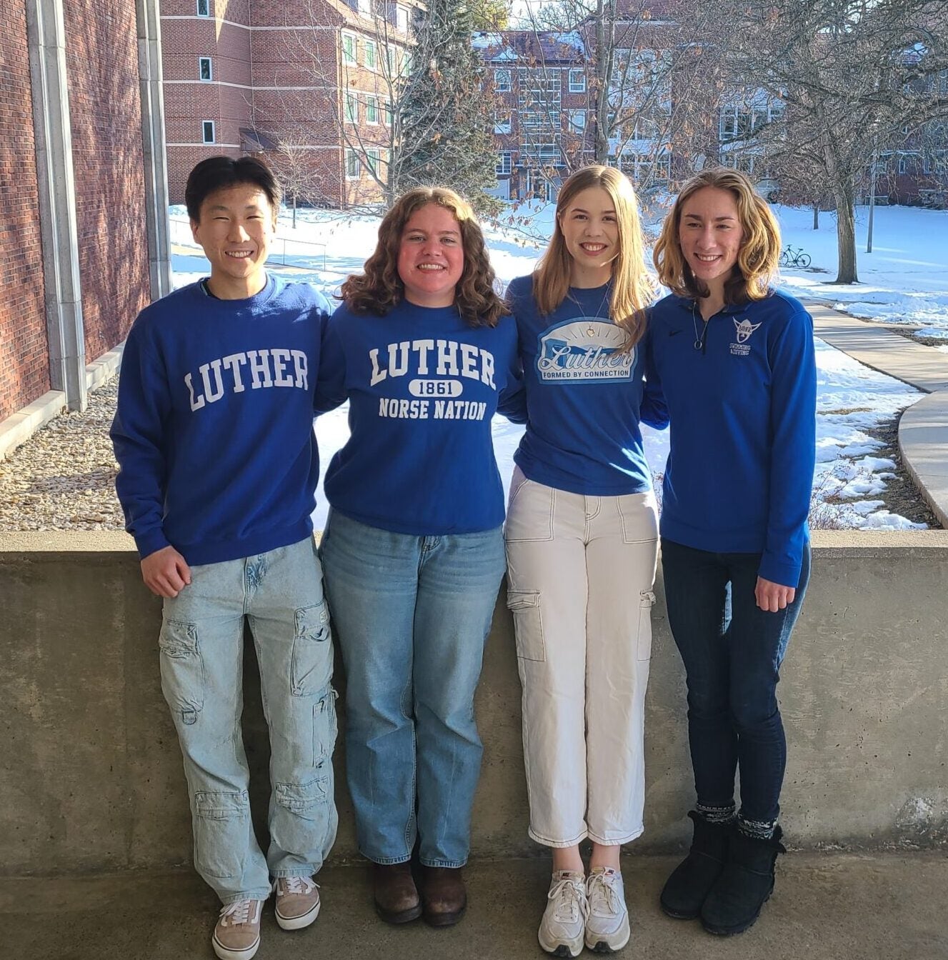 Peer Coach team of four students posing outside.