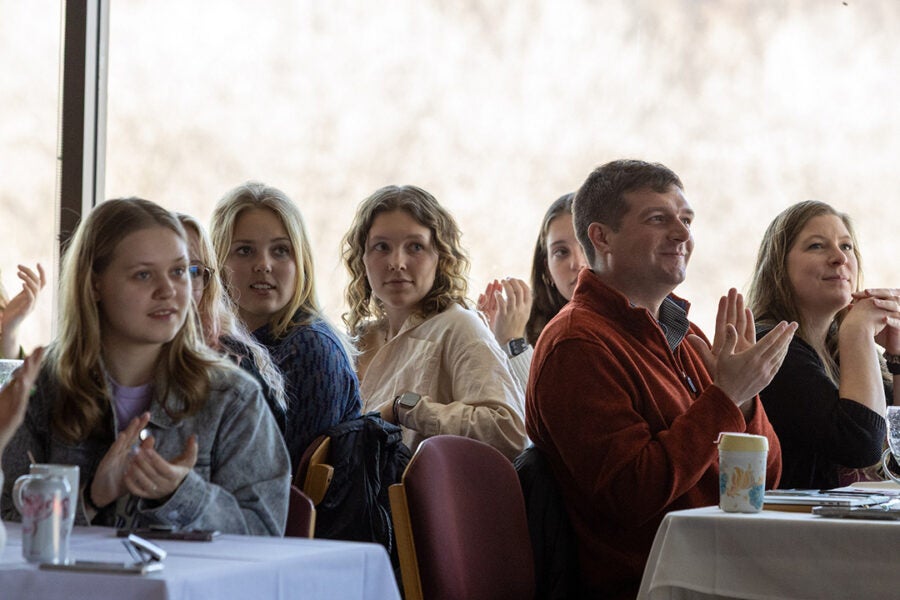 people listen to a speaker at a luncheon