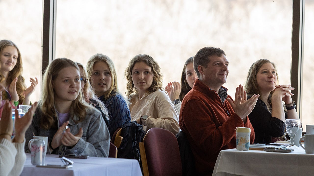 people listen to a speaker at a luncheon