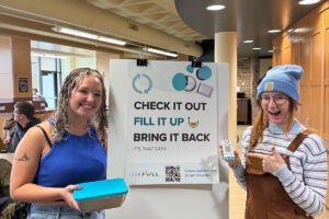 Luther College students stand next to a sign encouraging students to download the USEFULL app