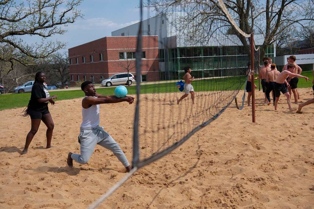 students playing sand volleyball