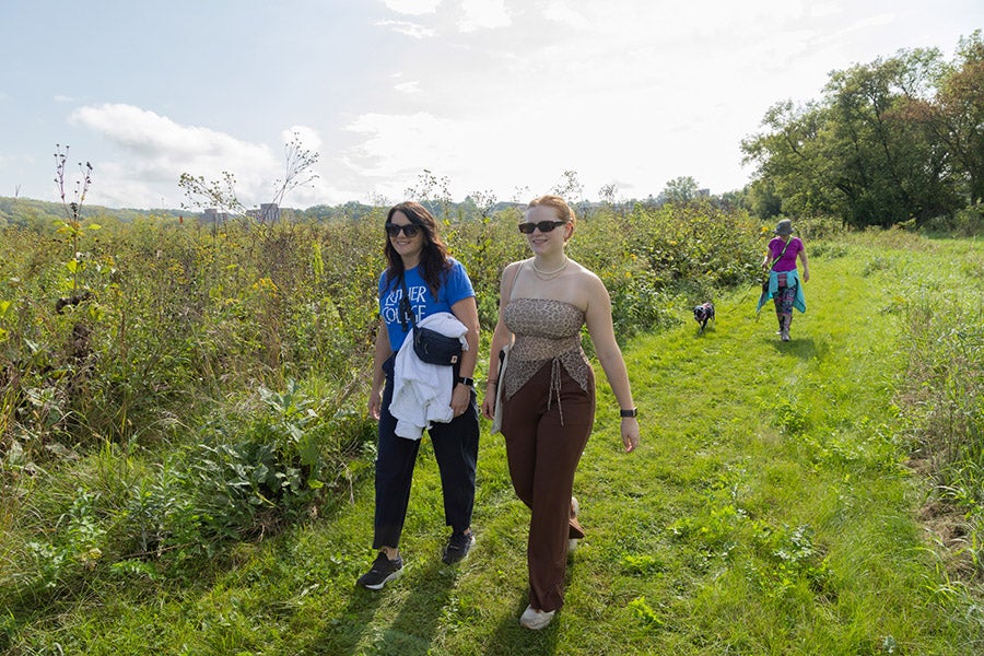 People walking on a mowed path in the prairie on a sunny day
