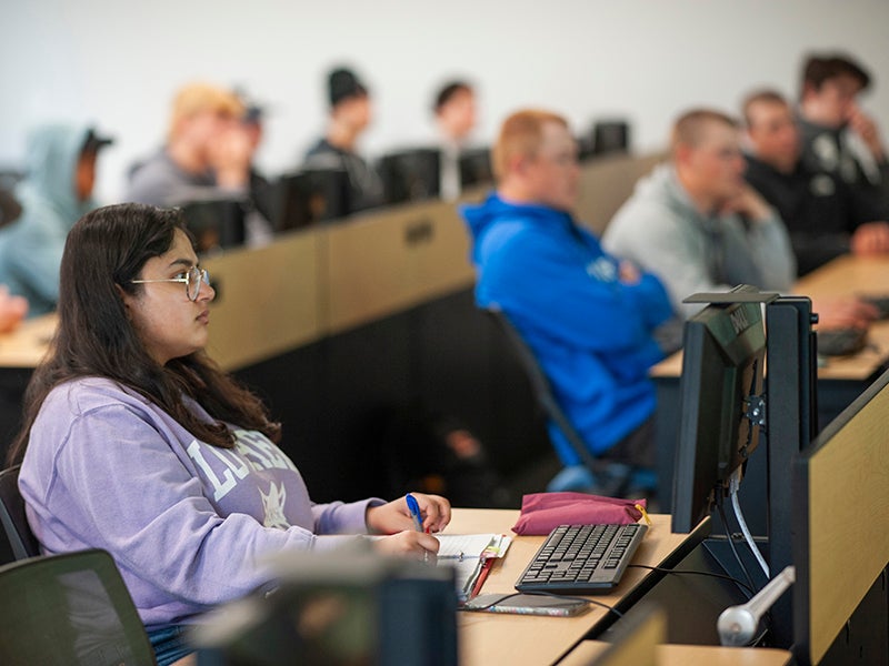 Students sitting in rows in a classroom.