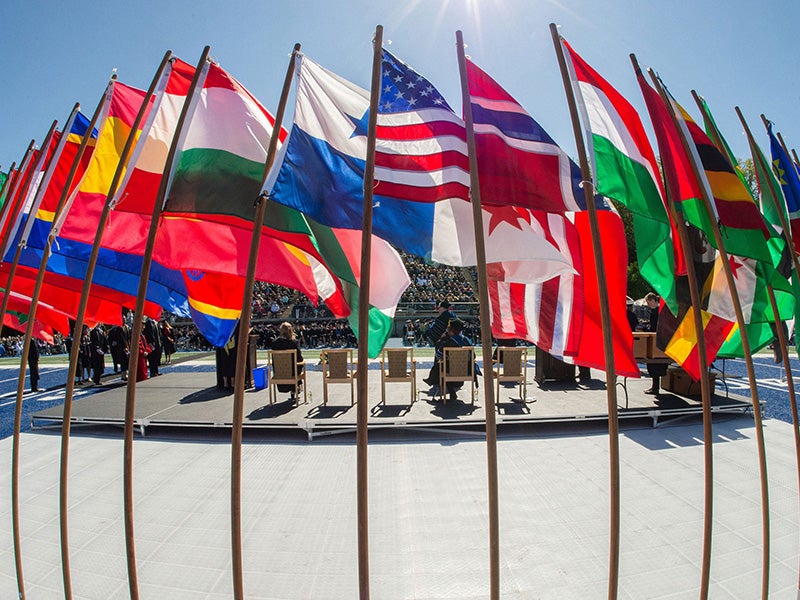 international flags displayed on an outdoor stage