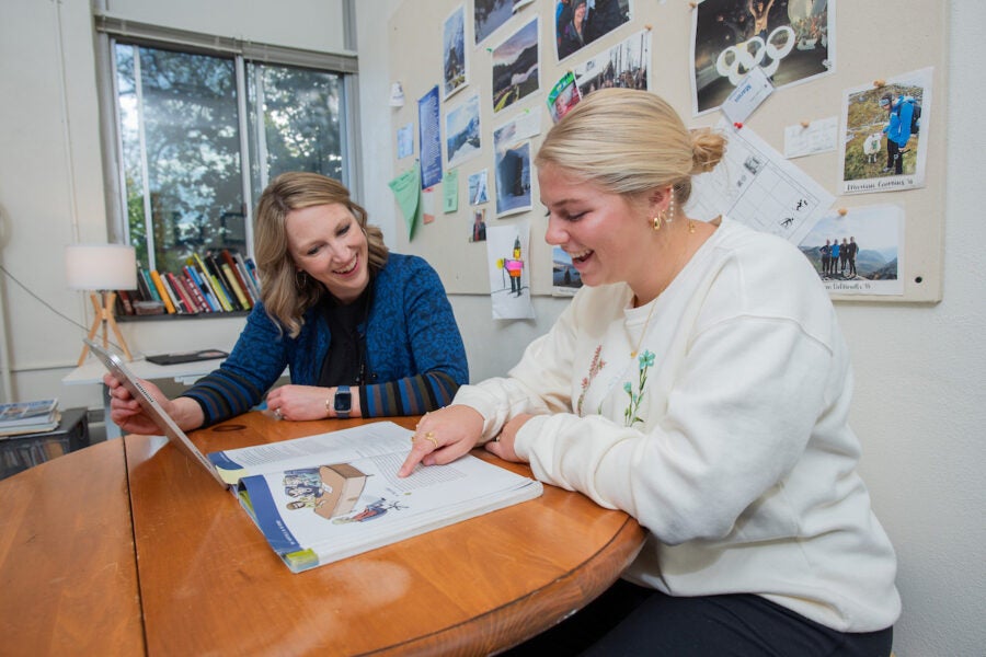 A professor meets with a collge student inside the professor's office.