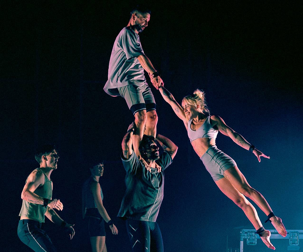 Participants of the acrobatic troupe Gravity and Other Myths perform a stunt