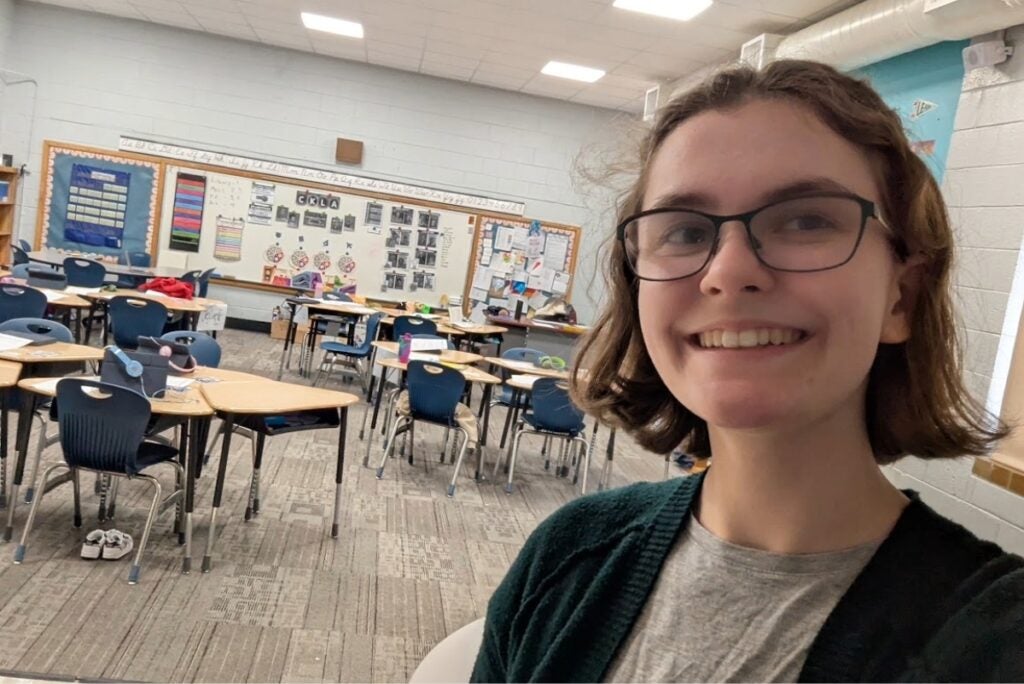 student teacher selfie in an elementary school classroom