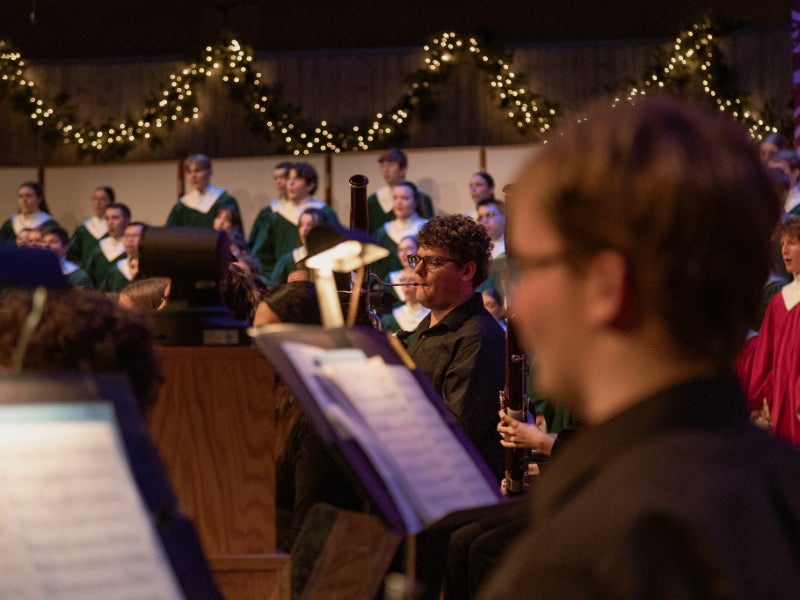 Student musicians and singers on stage, performing for Christmas at Luther