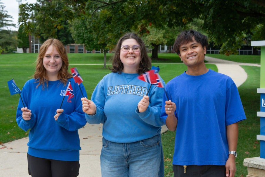 three college students wave small flags