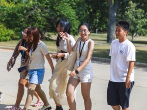 Five students walking together