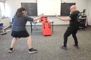a college student practices self-defense techniques