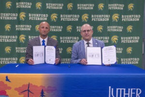 Rushford-Peterson Schools Superintendent Ben Bernard (left) and Luther College President Brad Chamberlain sit at a table