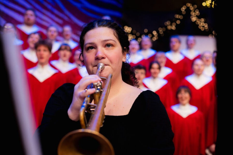 College student plays the trumpet at a Christmas concert