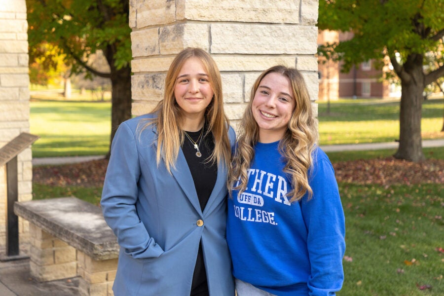 Two Luther College students stand outside for a photo